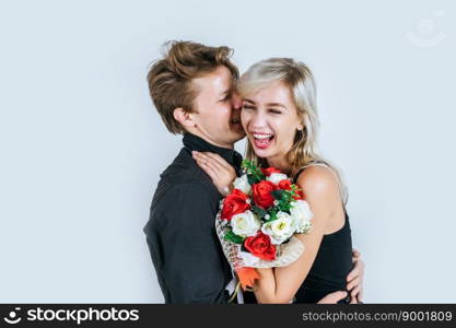 Portrait of happy young couple love together with flower in studio