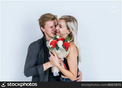 Portrait of happy young couple love together with flower in studio