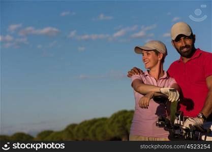 portrait of happy young couple on golf course