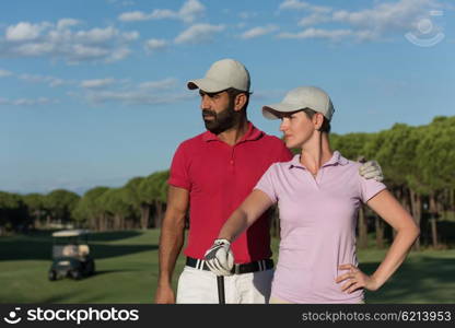 portrait of happy young couple on golf course