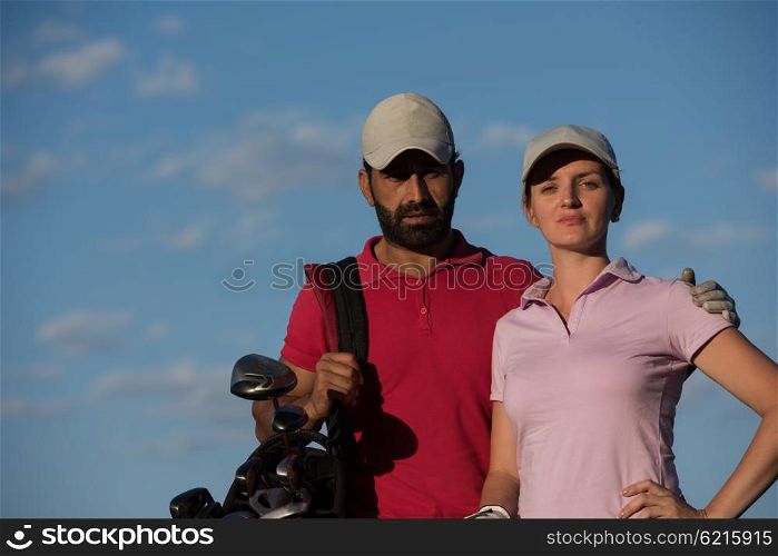 portrait of happy young couple on golf course