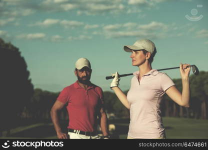 portrait of happy young couple on golf course. portrait of couple on golf course