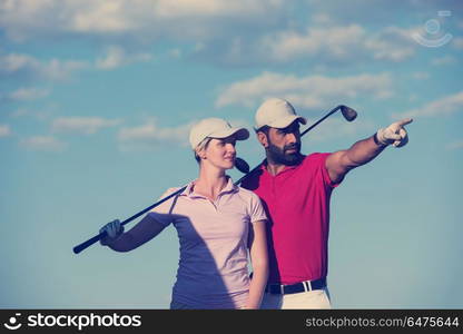 portrait of happy young couple on golf course. portrait of couple on golf course