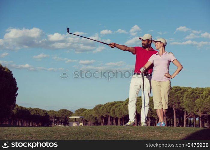 portrait of happy young couple on golf course. portrait of couple on golf course