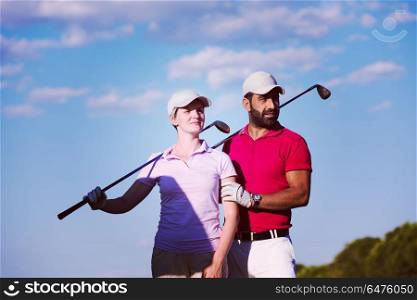 portrait of happy young couple on golf course. portrait of couple on golf course
