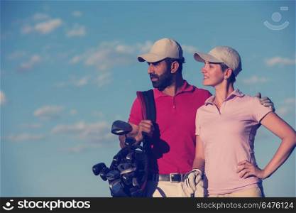 portrait of happy young couple on golf course. portrait of couple on golf course