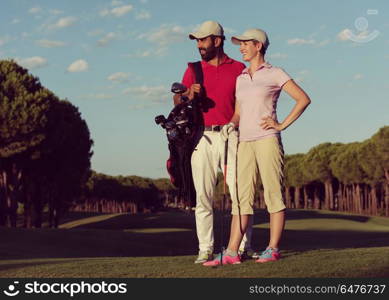 portrait of happy young couple on golf course. portrait of couple on golf course