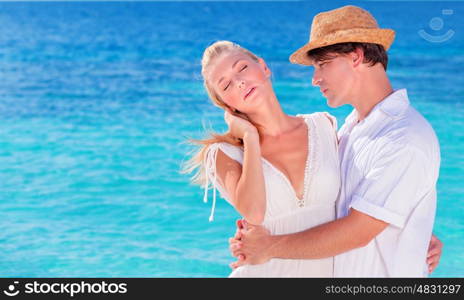 Portrait of happy young family in love, hugging on the beach, romantic relationship, summer vacation, gentle loving feelings concept