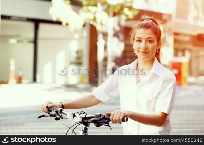 Portrait of happy young female bicyclist. Portrait of happy young female bicyclist riding in city