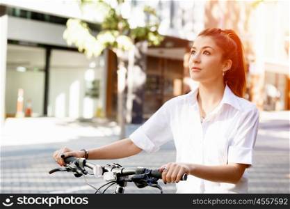 Portrait of happy young female bicyclist. Portrait of happy young female bicyclist riding in city