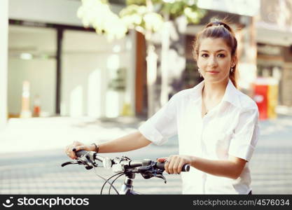 Portrait of happy young female bicyclist. Portrait of happy young female bicyclist riding in city