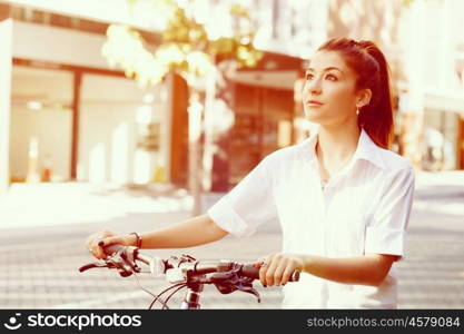 Portrait of happy young female bicyclist. Portrait of happy young female bicyclist riding in city