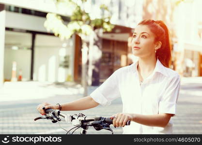 Portrait of happy young female bicyclist. Portrait of happy young female bicyclist riding in city