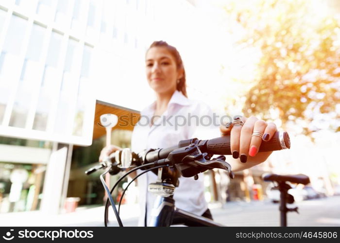 Portrait of happy young female bicyclist. Portrait of happy young female bicyclist riding in city