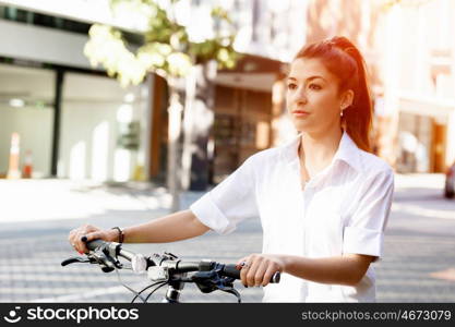 Portrait of happy young female bicyclist. Portrait of happy young female bicyclist riding in city