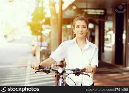 Portrait of happy young female bicyclist. Portrait of happy young female bicyclist riding in city
