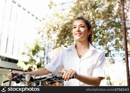 Portrait of happy young female bicyclist. Portrait of happy young female bicyclist riding in city