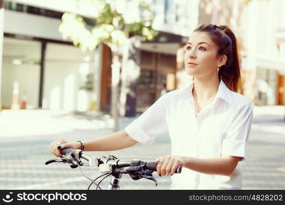 Portrait of happy young female bicyclist. Portrait of happy young female bicyclist riding in city