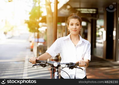 Portrait of happy young female bicyclist. Portrait of happy young female bicyclist riding in city