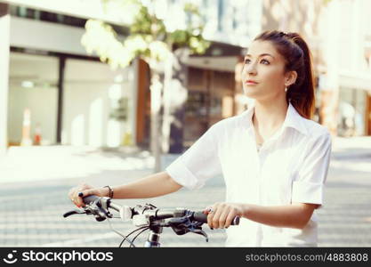 Portrait of happy young female bicyclist. Portrait of happy young female bicyclist riding in city