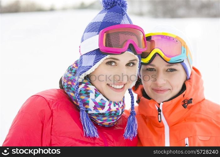 Portrait of happy young female friends in warm clothing outdoors