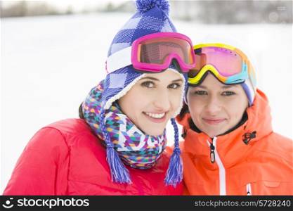 Portrait of happy young female friends in warm clothing outdoors