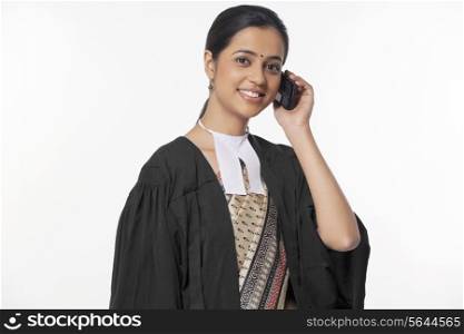 Portrait of happy young female lawyer on call isolated over white background