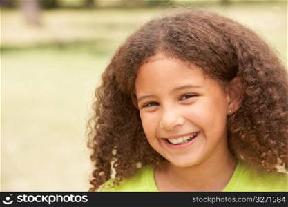Portrait Of Happy Young Girl In Park