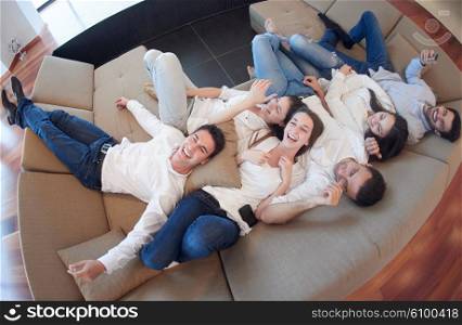 portrait of happy young group of friends get releax and have fun at modern home interior, top view
