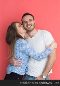 portrait of happy young loving couple looking at camera isolated on red Background