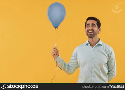 Portrait of happy young man holding balloon in hand