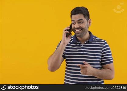 Portrait of happy young man talking on Smartphone
