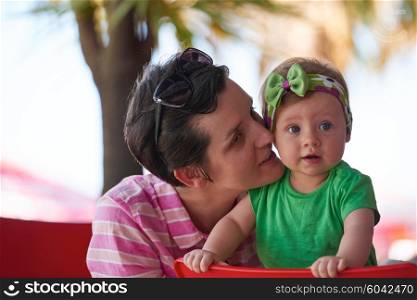 portrait of happy young mother and baby while have fun