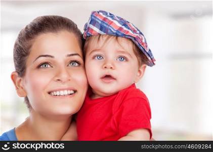Portrait of happy young mother with cute little son at home, with pleasure spending time together, enjoying motherhood