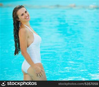 Portrait of happy young woman at pool