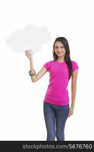 Portrait of happy young woman holding thought bubble over white background