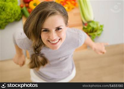 Portrait of happy young woman in kitchen