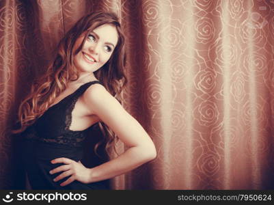 Portrait of happy young woman in lingerie.. Portrait of happy seductive woman wearing lingerie at home. Attractive sensual smiling young girl with long hair. Female underwear fashion.
