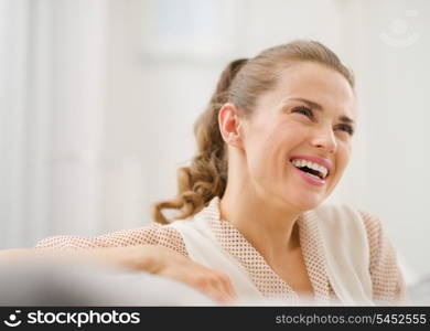 Portrait of happy young woman in living room