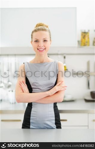 Portrait of happy young woman in modern kitchen