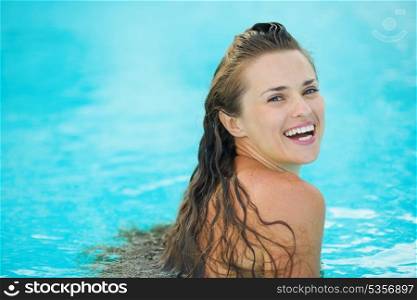 Portrait of happy young woman in pool