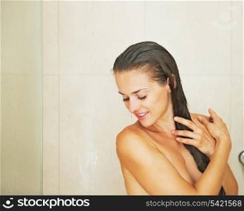Portrait of happy young woman in shower