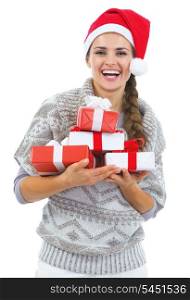 Portrait of happy young woman in sweater and christmas hat with christmas present boxes