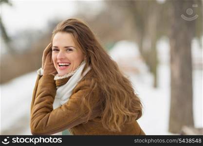 Portrait of happy young woman in winter outdoors