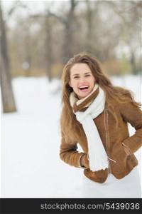 Portrait of happy young woman in winter park