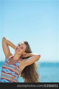 Portrait of happy young woman on beach