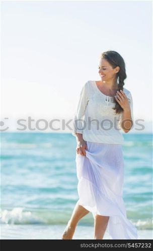 Portrait of happy young woman on sea coast