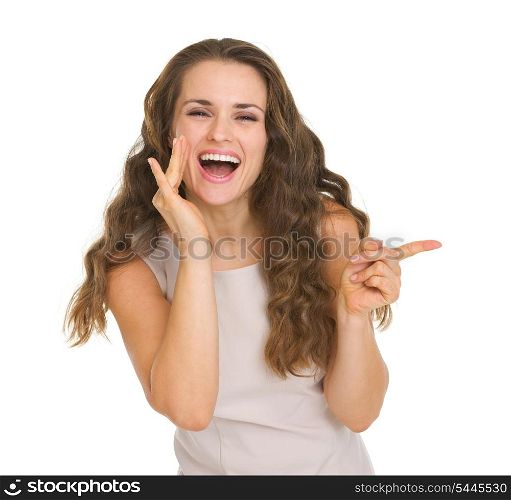 Portrait of happy young woman pointing on copy space
