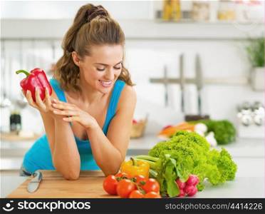 Portrait of happy young woman ready to make fresh vegetable salad