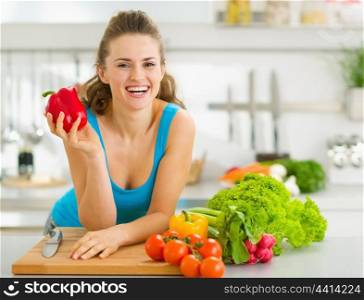 Portrait of happy young woman ready to make vegetable salad